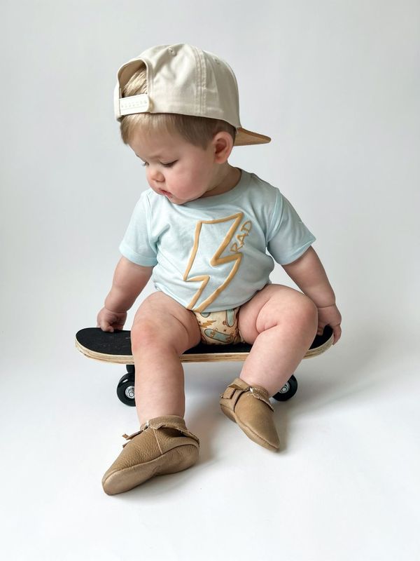 light blue boys tee with yellow lightening bolt paired with matching shorts hat and shoes